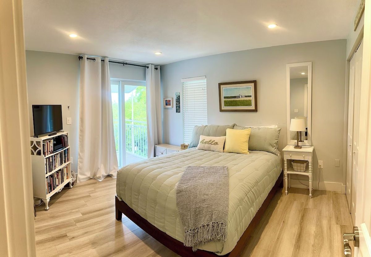 Bedroom with queen bed and balcony doors in the four-bedroom Key Largo vacation rental