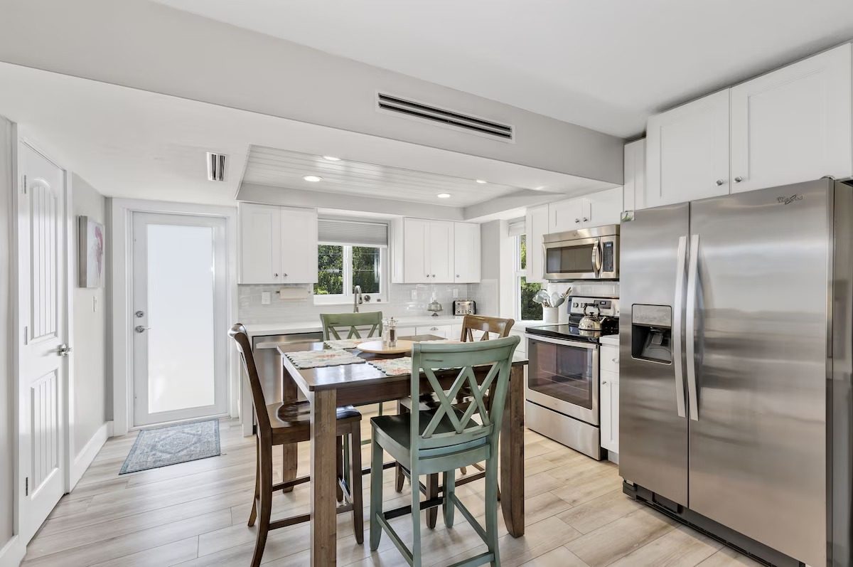 Kitchen with stainless steel appliances and dining table in this Key Largo rental home