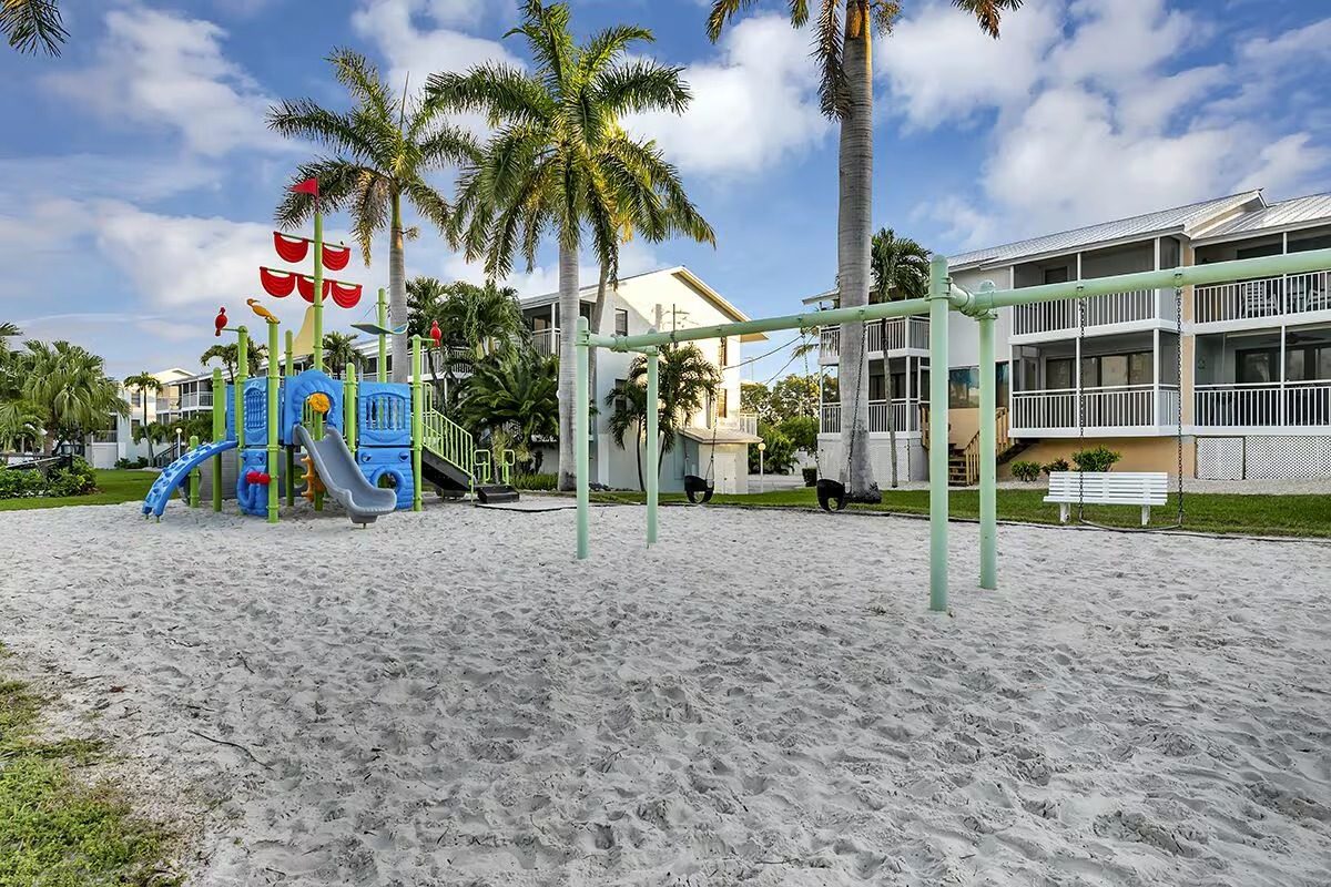 Children's playground on the sand under palm trees, family friendly Key Largo rental