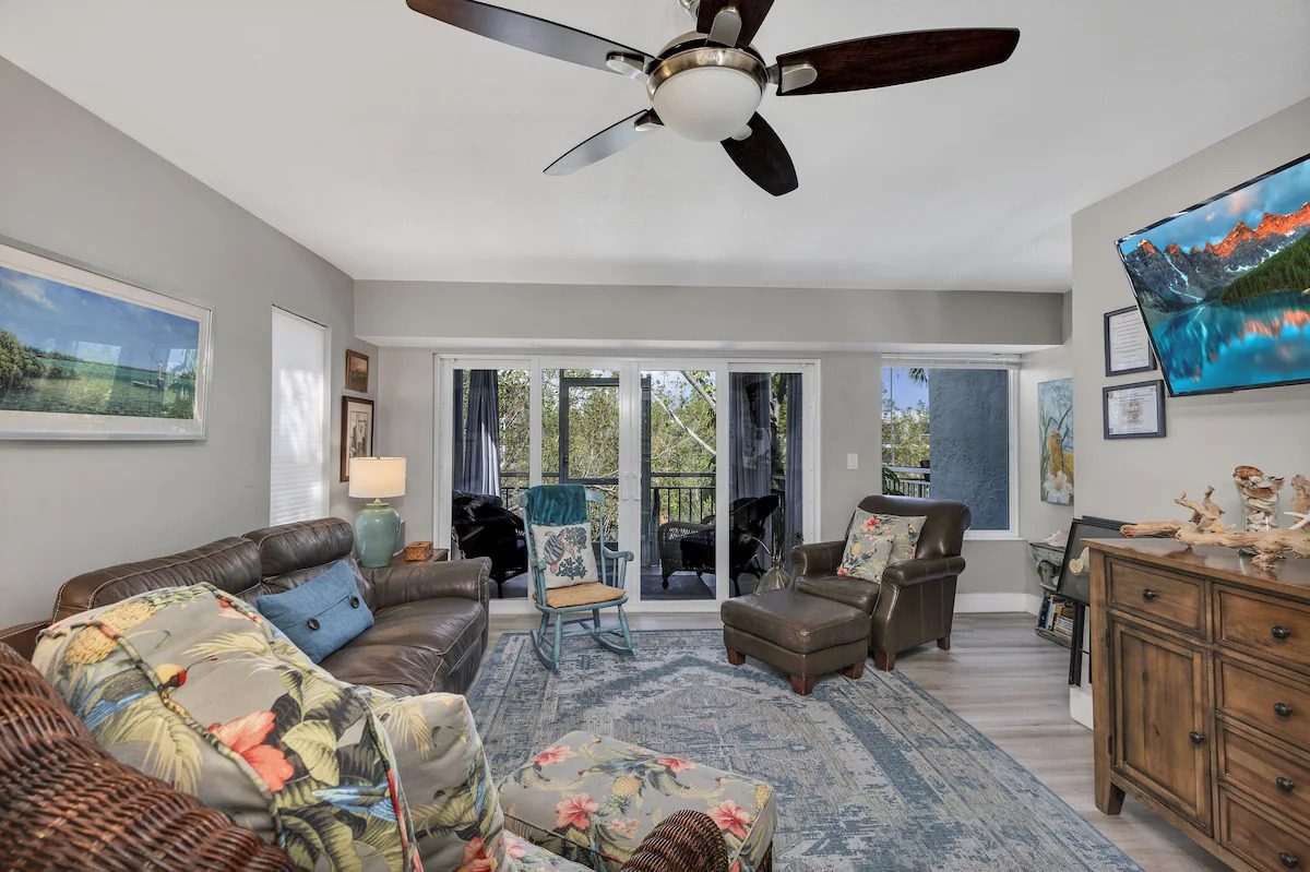 Living room with sliding doors opening onto a balcony in the Key Largo vacation home