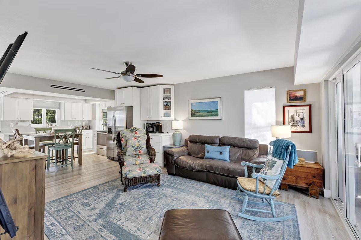 Open living room and dining area with ceiling fan in the four-bedroom Key Largo rental