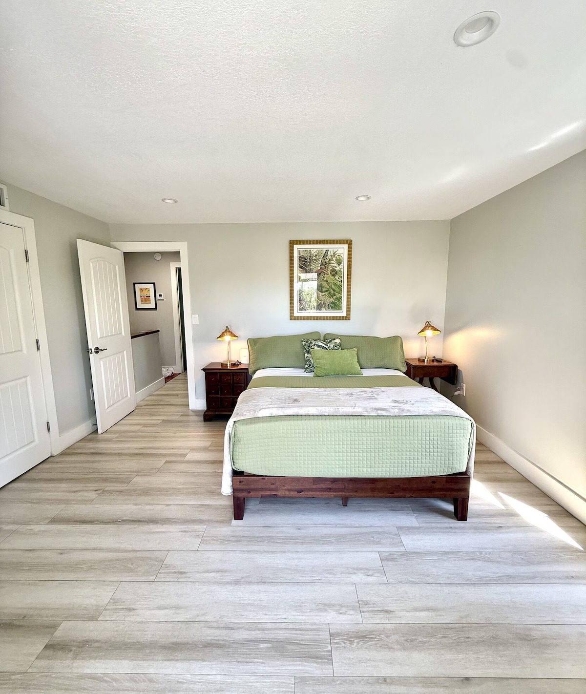Second bedroom with a green quilted bed in the Key Largo rental that sleeps eight